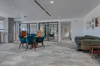 A living room with a grey carpet and a green sofa.